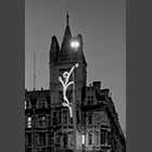 monochrome photo of Gonville and Caius College at dusk with Christmas lights