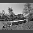 monochrome photo of the Community Play Boat moored on the Cam